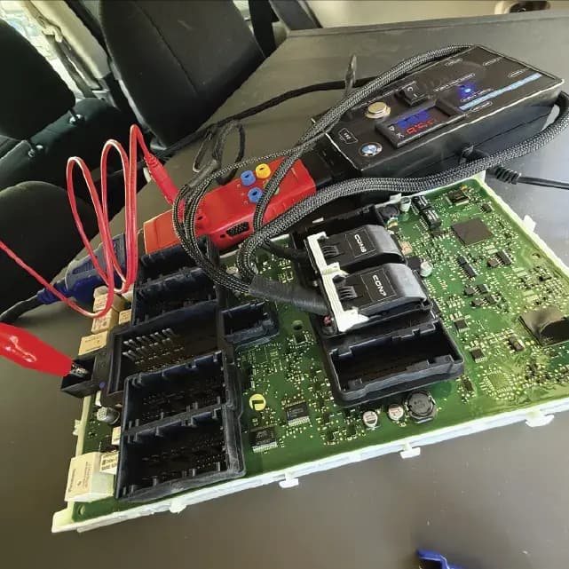 Mobile locksmith cutting and programming a new car key at the vehicle after all keys were lost