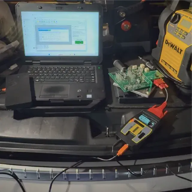 Automotive locksmith performing car key replacement on-site with mobile van