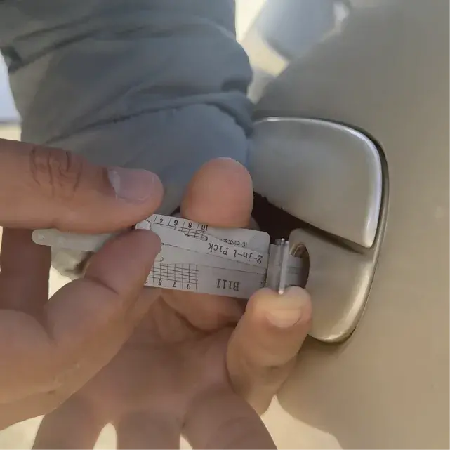 Mobile auto locksmith opening a car door without damage during a 4Keys car lockout call