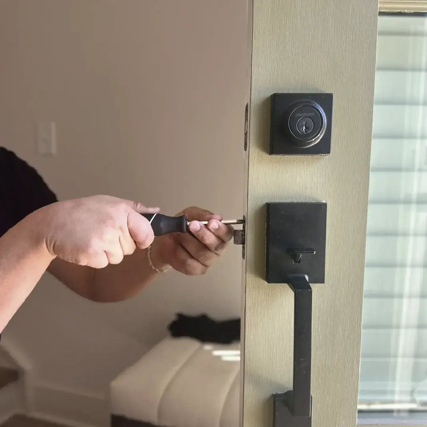 Residential locksmith installing smart lock on home front door